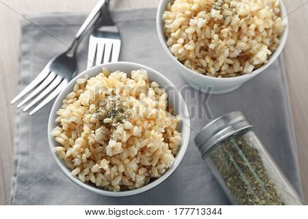 Two bowls of brown rice on napkin