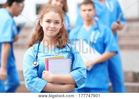 Young student with groupmates outdoors