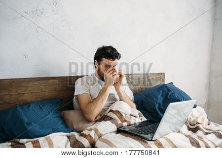 Bearded Man Lying In Morning Bed With Coffee Or Tea Cup