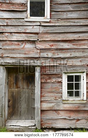 Traditional norwegian wooden red colored cabin houses facades. Otternes Norway