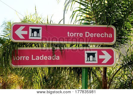 Two signs pointing in opposite directions for the old watchtower the Torre Ladeada and the Torre Derecha Lagos Malaga Province Andalusia Spain Western Europe.