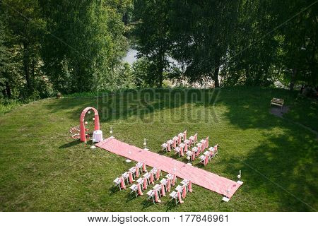 Wedding registration beautiful in nature. White chairs for visiting registration. Pink tent with white flowers for the exit registration. White and pink peonies with roses. Wedding details