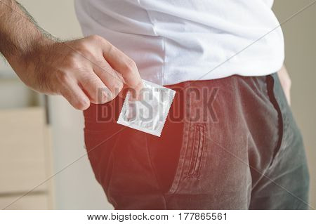 Closeup Of Man Having Condom In Pocket Ready To Use