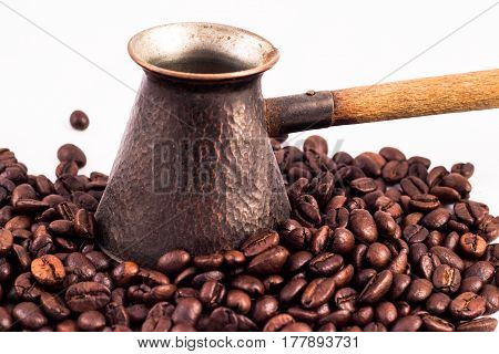 Armenian Jazva, Small Pot For Making Coffee. Many Coffee Beans In The Background. Texture Of The Cof