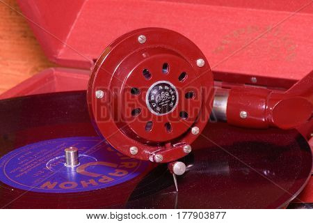 HUSTOPECE CZECH REPUBLIC - MARCH 10 2017: Image shows vintage gramophone (famous Czech brand Supraphone). The red wind-up gramophone and vinyl record (brand Ultraphon).