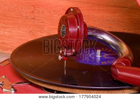 HUSTOPECE CZECH REPUBLIC - MARCH 10 2017: Image shows vintage gramophone (famous Czech brand Supraphone). The red wind-up gramophone and vinyl record (brand Ultraphon).