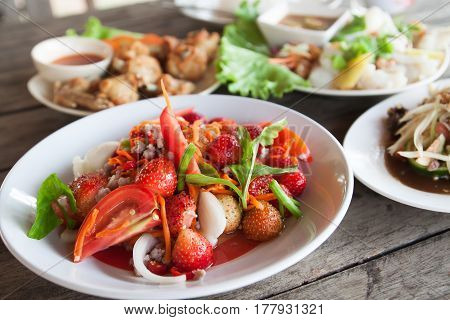 Strawberry spicy salad on white plate Spacial menu in Thailand