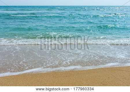 Light Waves Washing Up On A Golden Sand Beach, With Depth Of Field.