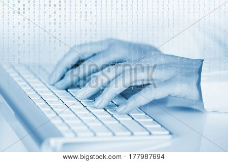 Studio shot of human hands on computer keyboard. Digitally toned and manipulated.