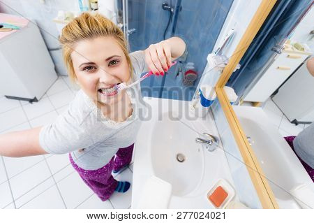 Woman Brushing Cleaning Teeth Closeup. Funny Blonde Girl With Toothbrush In Bathroom. Oral Hygiene. 