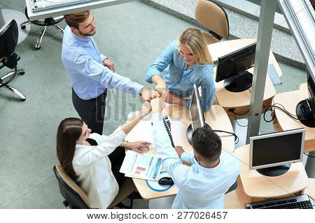 Top View Of Young Modern Colleagues In Smart Casual Wear Working Together While Spending Time In The