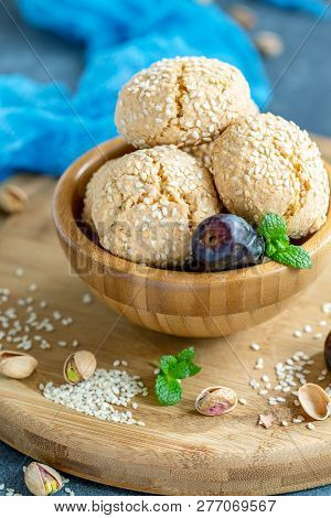 Wooden Bowl With Traditional Sesame Cookies On The Serving Board, Selective Focus.