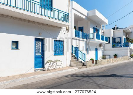 Sifnos, Greece - September 10, 2018: Beautiful Whitewashed Greek Architecture With Blue Windows And 