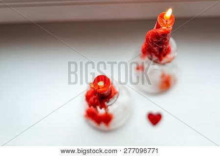 St. Valentine's Red Candles On The Windowsill