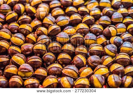 Bunch Of Roasted Chestnuts At Street Wendor. Roasted Chestnuts, Street Food