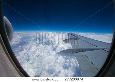 View From The Window Of The Plane Onto The Wing And Engines Of A Fokker 100 Model With A Blue Sky An