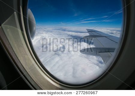 View From The Window Of The Plane Onto The Wing And Engines Of A Fokker 100 Model With A Blue Sky An