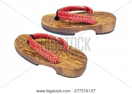 Close Up Old Used Wooden Japanese Sandal Isolated On White Background. It Is A Form Of Traditional J