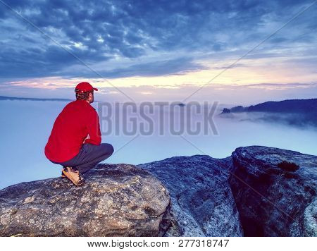 Man Lost In Thick Mist Rocks. Hiker Climbed Up Alone To Exposed Summit Above Heavy Fog. Biig Adventu