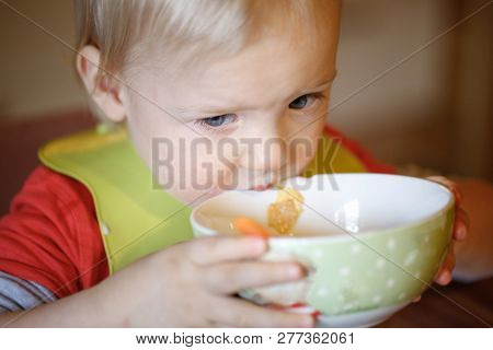 Little Boy Drinking Independently From A Bowl