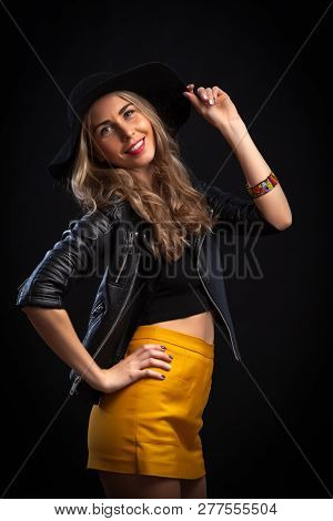 Smiling Beautiful Young Woman In Pink Mini Dress Posing With Hands On Hat. Three Quarter Length Stud