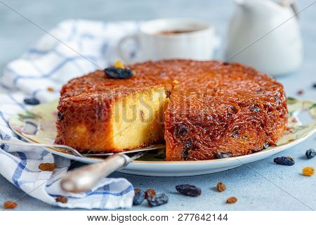 Piece Of Kugel Dessert Of Jewish Cuisine Made Of Noodles, Eggs And Raisins On A Close-up Dish, Selec