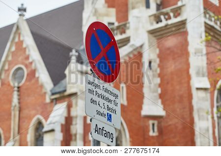 Road Sign No Parking In The City On The Background Of The Old Red Cathedral, Viena, Austria