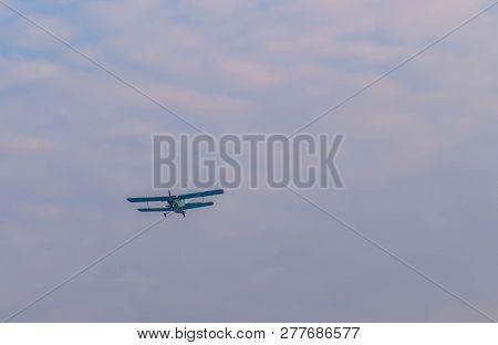 Military Biplane In Cloudy Sky