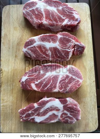 Raw Shoulder Pork Steak On A Cutting Board