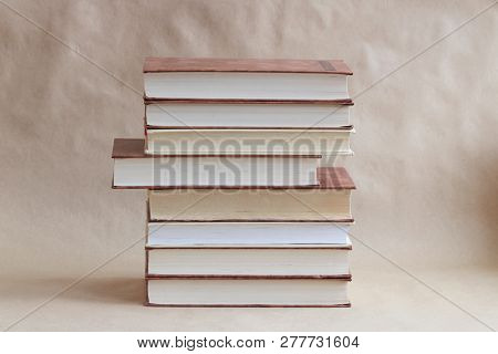 Stack Of Different Old Book On A Beige Background. Library And Literature Concept. Education And Kno