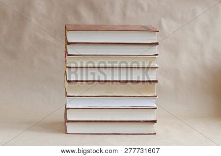 Stack Of Old Book On A Beige Background. In The Center