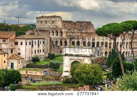 View Of Colosseum And Ruins Of Roman Forum. Arch Of Titus And Others In Rome. Italy