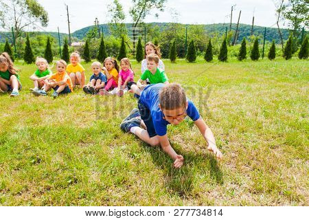 Schoolboy Crowling On Knees In Front Of His Mates