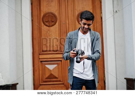Stylish Indian Young Man Photographer Wear Casual Posed Outdoor With Dslr Photo Camera At Hands.