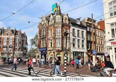 Amsterdam, Netherlands - July 7, 2017: People Visit Muntplein Square In Amsterdam, Netherlands. Amst