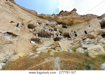 Old Ancient Temple And Residential Caves Carved On The Top Of A Rocky Hill In The Sandstone Mountain