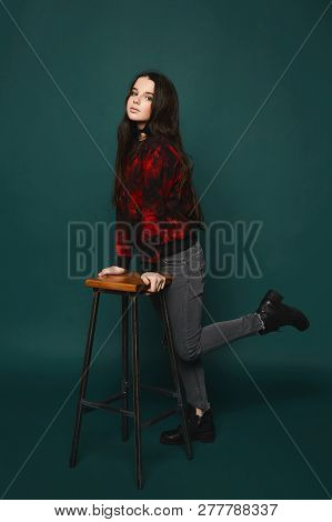 Beaytiful And Fashionable Brunette Teen Model Girl In Stylish Grey Jeans And In The Black Sweatshirt