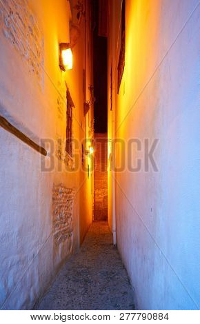 Albaicin of Granada narrow street at sunset of Andalusia muslim Spain