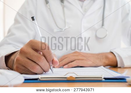 Healthcare Medical Expenses Concept, Hands Doctor's Writing And Working On Prescription Clipboard Wi