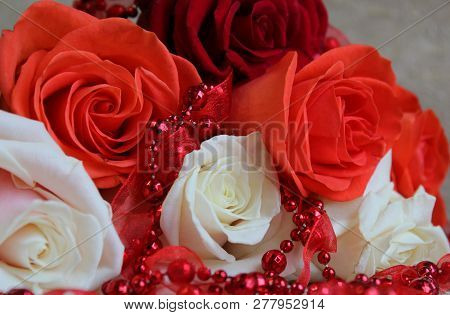 Pink And White Roses With Red Beads On A Light Background. Close-up