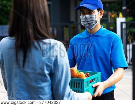 Asian Delivery Man Delivering Food, Fruit, Joice And Vegetable To Customer Home - Online Grocery Sho