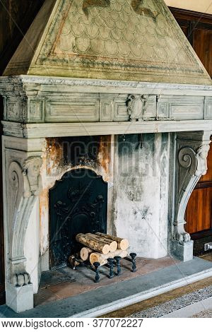 Old Firebox In The House Close-up. An Ancient Fireplace In The House With Columns And Bas-reliefs.