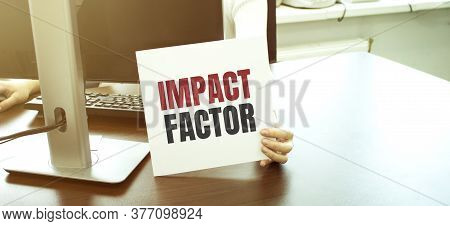 Businesswoman Holding A Card With Text Impact Factor