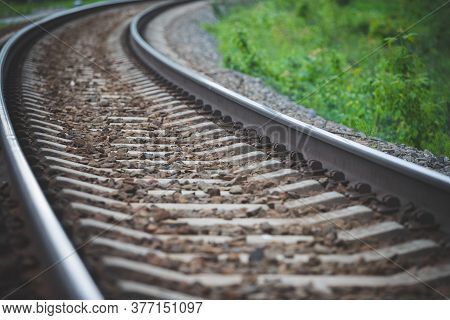 Rounded Railway Rails Extending Into The Distance. Curved Rails. Slewing Rails. Selective Focus.