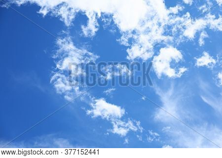 Blue Summer Sky With Bright White And Light Clouds
