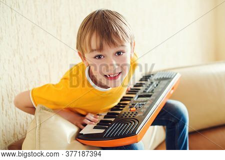 Boy Learning To Play The Synthesizer. Music Education And Extra-curricular Lessons. Development Of M