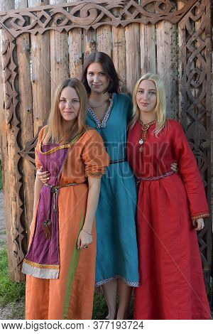 Three Girls Dressed In Historical Medieval Reconstruction Varangian Manor, Russia