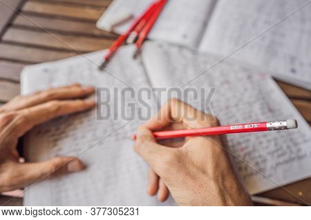 Vietnam, Nha Trang, 14.07.2020: Ielts Red Pencils And Essay Notebook For The English Exam