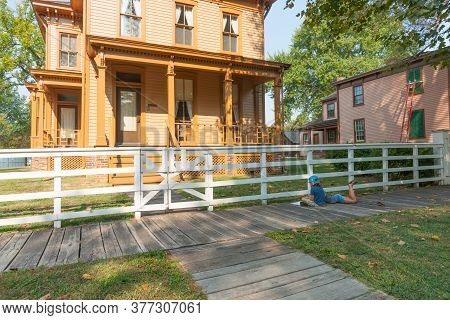 Springfield, Illinois, Usa September 1 2015; Two Children On Shady Sidewailk Studying Information Ab