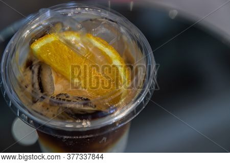 Iced Coffee With Orange Or Yuzu Espresso Tonic - Close-up A Plastic Glass Of Espresso Mixed With Ton